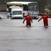 Firefighters make their way through flood water on the A811 as torrential rain continued on 7 October in Drymen, Stirlingshire (Picture: Jeff J Mitchell/Getty Images)