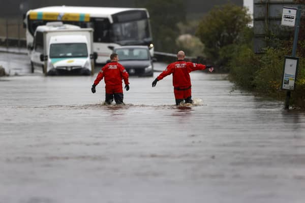 Firefighters make their way through flood water on the A811 as torrential rain continued on 7 October in Drymen, Stirlingshire (Picture: Jeff J Mitchell/Getty Images)