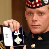 Corporal Shaun Garry Jardine of the King's Own Scottish Borderers holds his conspicuous gallantry cross.