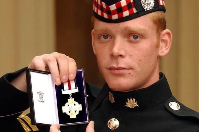 Corporal Shaun Garry Jardine of the King's Own Scottish Borderers holds his conspicuous gallantry cross.