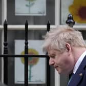 Prime Minister Boris Johnson walks past children's sunflower pictures, made in solidarity with Ukraine amid the ongoing Russian invasion. Picture: AP Photo/Matt Dunham