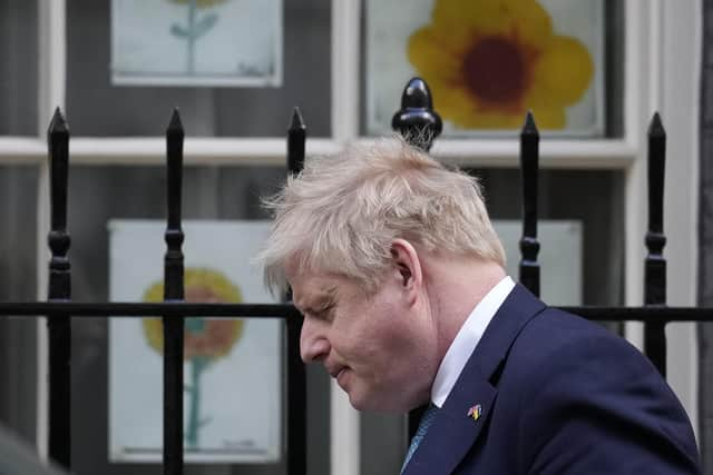 Prime Minister Boris Johnson walks past children's sunflower pictures, made in solidarity with Ukraine amid the ongoing Russian invasion. Picture: AP Photo/Matt Dunham