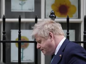 Prime Minister Boris Johnson walks past children's sunflower pictures, made in solidarity with Ukraine amid the ongoing Russian invasion. Picture: AP Photo/Matt Dunham