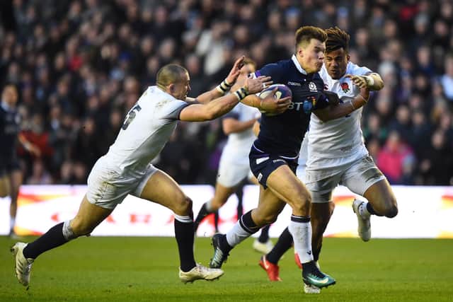England's Anthony Watson and Mike Brown have gold hold of Jones but they can't stop him scoring in the Calcutta Cup triumph of 2018