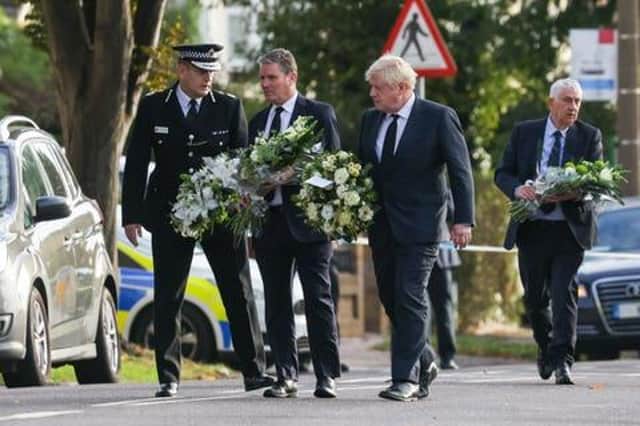 Chief Constable Ben-Julian Harrington, Labour Party leader Keir Starmer, Prime Minister Boris Johnson, and Speaker of the House Sir Lindsay Hoyle carry flowers as they arrive at the scene near Belfairs Methodist Church in Eastwood Road North