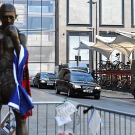 The funeral procession of legendary Scottish boxing world champion Ken Buchanan MBE passes the Ken Buchanan statue ahead of a memorial service