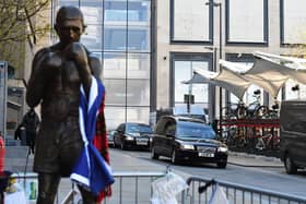 The funeral procession of legendary Scottish boxing world champion Ken Buchanan MBE  passes the Ken Buchanan statue ahead of a memorial service