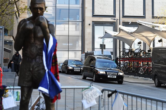 The funeral procession of legendary Scottish boxing world champion Ken Buchanan MBE  passes the Ken Buchanan statue ahead of a memorial service