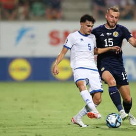 Scotland defender Ryan Porteous challenges Cyprus midfielder Charalampos Charalampous. (Photo by Ryan Pierse/Getty Images)