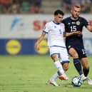 Scotland defender Ryan Porteous challenges Cyprus midfielder Charalampos Charalampous. (Photo by Ryan Pierse/Getty Images)