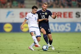 Scotland defender Ryan Porteous challenges Cyprus midfielder Charalampos Charalampous. (Photo by Ryan Pierse/Getty Images)