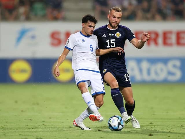 Scotland defender Ryan Porteous challenges Cyprus midfielder Charalampos Charalampous. (Photo by Ryan Pierse/Getty Images)