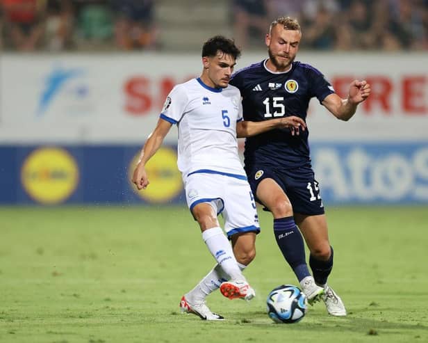 Scotland defender Ryan Porteous challenges Cyprus midfielder Charalampos Charalampous. (Photo by Ryan Pierse/Getty Images)