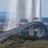The hearse carrying the coffin of Queen Elizabeth II, draped with the Royal Standard of Scotland, passing over the Queensferry Crossing as it continues its journey to Edinburgh from Balmoral on Sunday