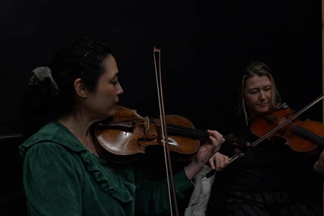 Left to right: Coralie Usmani (musical director) and Sarah Beattie (fiddler) in rehearsals for A Play For Tory