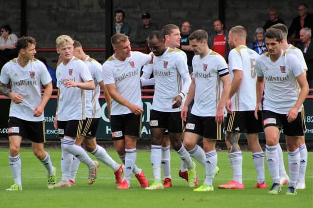 All 10 outfield players celebrate Julian Wade's equaliser. (Photo: Ian Rennie)