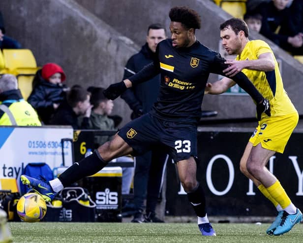 Livingston's Caleb Chukwuemeka holds off Ross County's Connor Randall during the Scottish Cup fourth round clash
