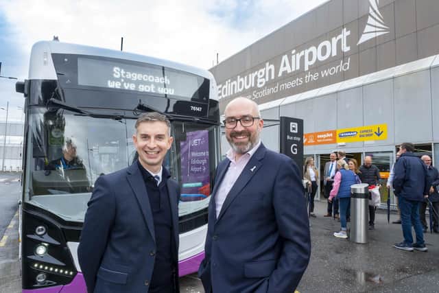 Stagecoach East Scotland Interim Managing Director David Frenz (left) and Gordon Robertson, Chief Communications and Sustainability Officer at Edinburgh Airport, in front of the new electric JET747 bus at Edinburgh Airport. (Pic: Peter Devlin)