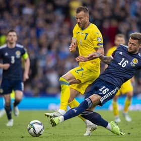 Scotland's Liam Cooper challenges Ukraine's Andriy Yarmolenko at Hampden on Wednesday. (Photo by Ross MacDonald / SNS Group)