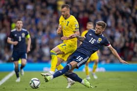 Scotland's Liam Cooper challenges Ukraine's Andriy Yarmolenko at Hampden on Wednesday. (Photo by Ross MacDonald / SNS Group)