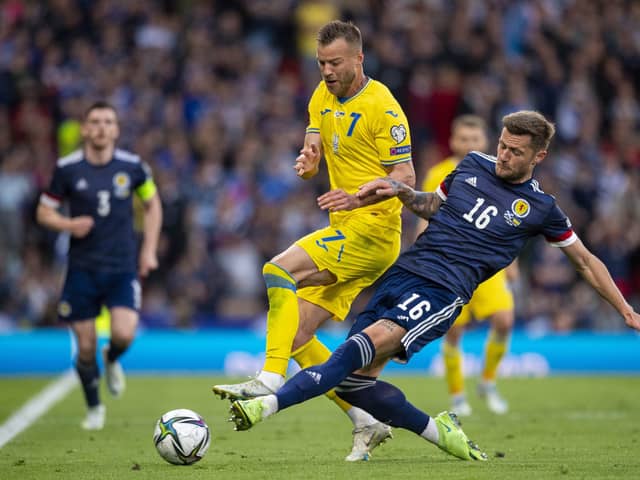 Scotland's Liam Cooper challenges Ukraine's Andriy Yarmolenko at Hampden on Wednesday. (Photo by Ross MacDonald / SNS Group)