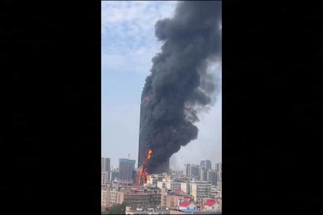 This screengrab taken from a video provided to AFPTV by an anonymous source on September 16, 2022 shows thick smoke billowing from a skyscraper in Changsha, in China's central Hunan province.   via Getty Images