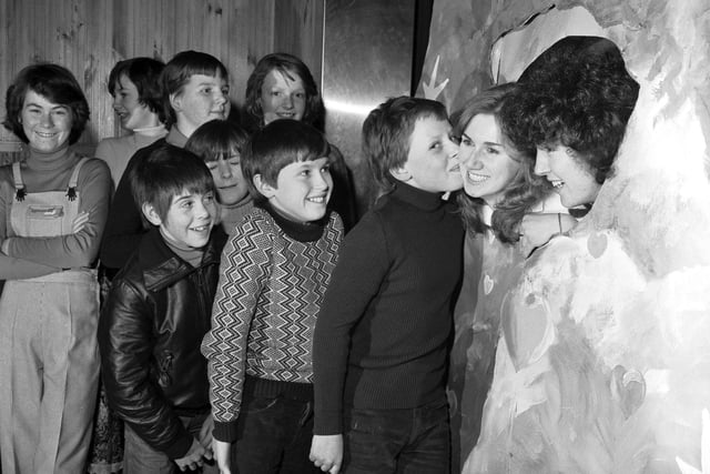 Teenage boys queue up to use the 'Kissing Booth' at the Inverkeithing High School Valentine's Day disco in 1979.