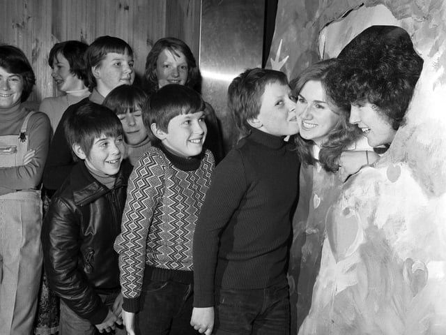 Teenage boys queue up to use the 'Kissing Booth' at the Inverkeithing High School Valentine's Day disco in 1979.