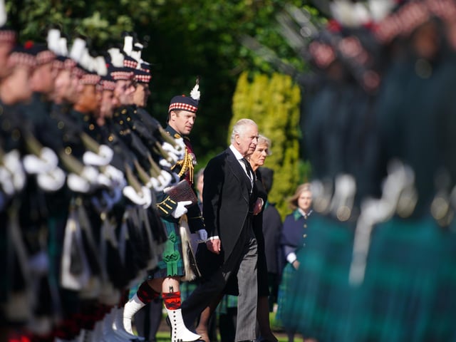 King Charles III and the Queen Consort inspect the Guard of Honour before the Ceremony of the Keys at the Palace of Holyroodhouse, Edinburgh. Picture date: Monday September 12, 2022.