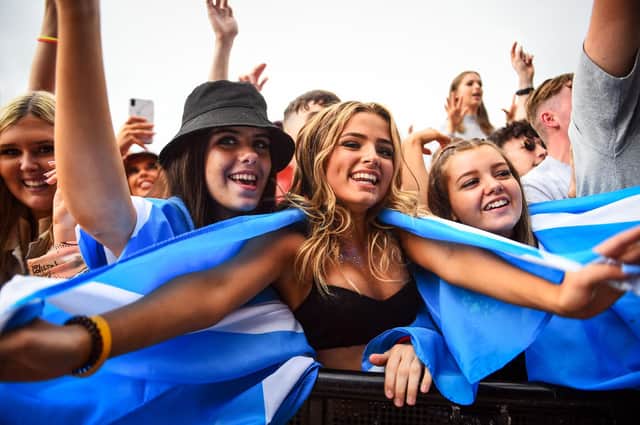 Festival-goers dance and cheer during the TRNSMT Festival on Glasgow Green (Photo by ANDY BUCHANAN/AFP via Getty Images)