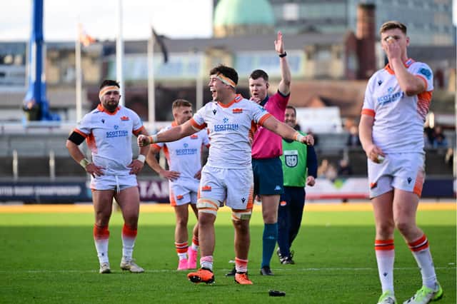 Tom Dodd leads Edinburgh's celebrations after the win over Dragons.