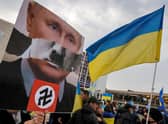 Vladimir Putin has been compared to Adolf Hitler by protesters all over the world, including these people in Tel Aviv, Israel, in March (Picture: Jack Guez/AFP via Getty Images)
