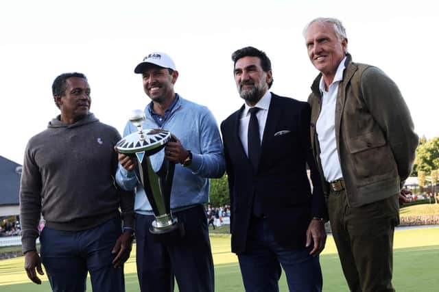 First-placed and winner South African golfer Charl Schwartzel (2nd L) celebrates with the trophy as he poses with CEO of LIV Golf Greg Norman (R) and Yasir Al-Rumayyan (2nd R).