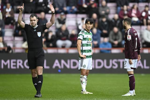 Celtic's Yang Hyun-jun watches referee Don Robertson signal he is going to the VAR monitor. The South Korean winger was subsequently sent off.