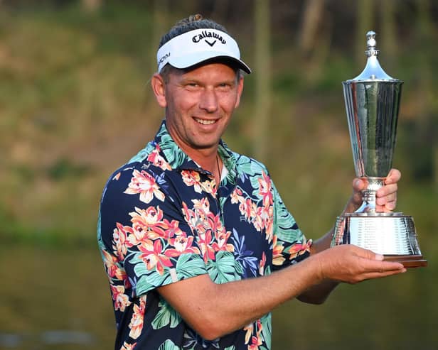Marcel Siem poses with the trophy after winning the Hero Indian Open at DLF Golf and Country Club. Picture: Sajjad Hussaian/AFP via Getty Images.