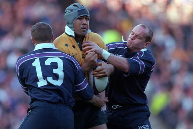 Toutai Kefu, playing for Australia, is tackled by Gregor Townsend, right, and Alan Bulloch during the Test against Scotland at Murrayfield in November 2000. Australia won 30-9. Picture: Matthew Impey/Shutterstock