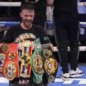 Josh Taylor celebrates while holding his belts after defeating Jose Ramirez by unanimous decision