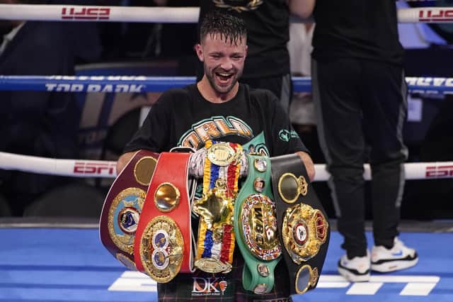 Josh Taylor celebrates while holding his belts after defeating Jose Ramirez by unanimous decision