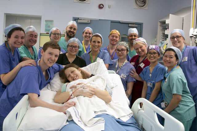 medical team celebrating first UK womb transplant birth