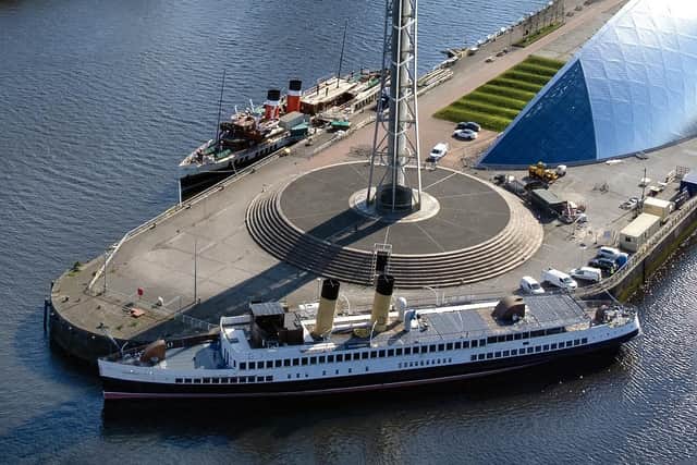 Queen Mary beside the Glasgow Science Centre tower this week with Waverley behind. Picture: John Devlin