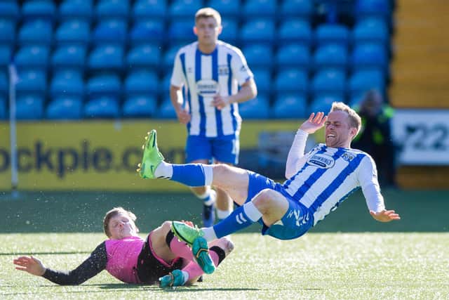 Queen of the South threatened to trip up Kilmarnock's promotion bid, just as Wullie Gibson did to Rory McKenzie, but Ash Taylor ensured Derek McInnes' side stayed top of the cinch Championship. (Picture: SNS/Sammy Turner)