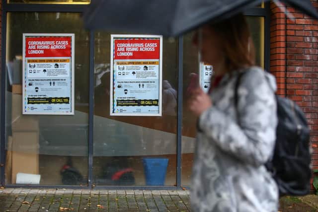 A pedestrian walks past Coronavirus posters Islington yesterday