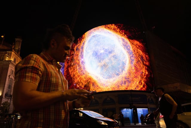 Nasa broadcasts the first images from the James Webb Space Telescope, the world's most advanced space telescope, on the Piccadilly Lights screen in London.