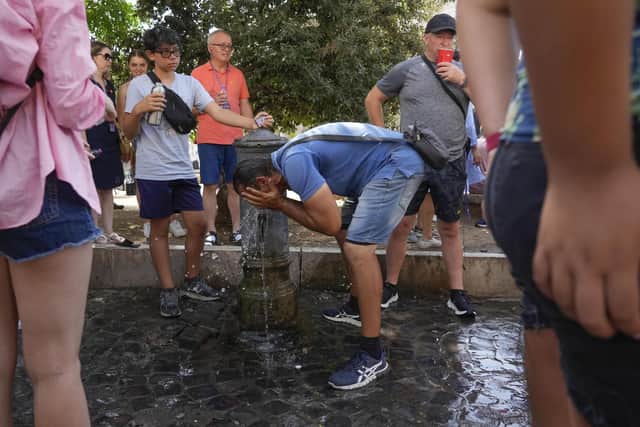 A man refreshes at a fountain in Rome. The Italian capital is top of the red alert list as one of the hottest cities in the country.