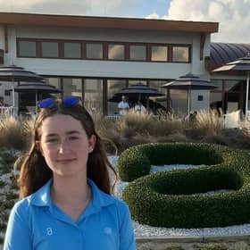 Grace Crawford stands in front of the Albany clubhouse during the final round of the Hero World Challenge on Sunday.