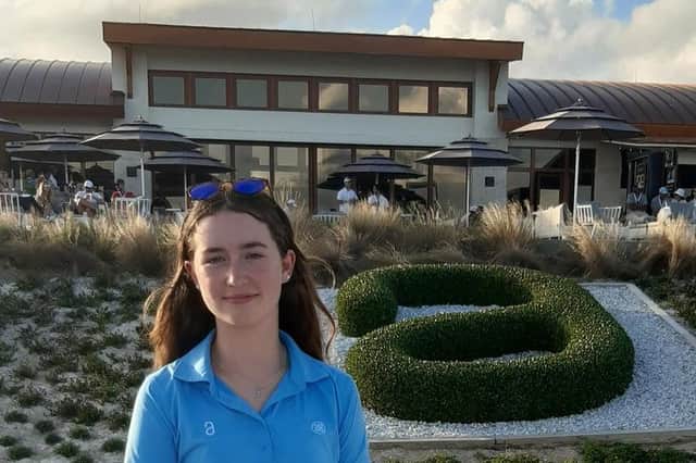 Grace Crawford stands in front of the Albany clubhouse during the final round of the Hero World Challenge on Sunday.