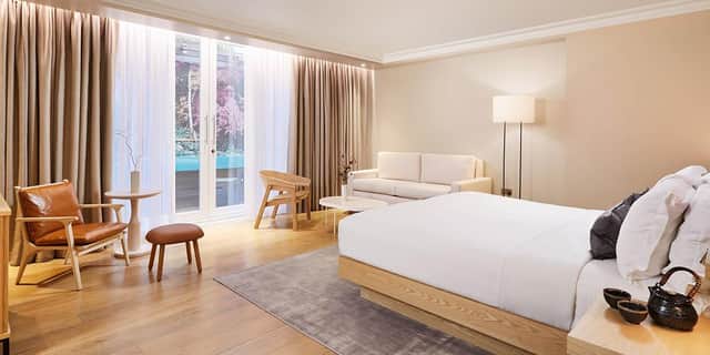 The calming neutral hues of a studio bedroom at The Prince Akatoki hotel, London.