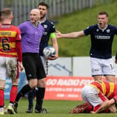A free kick is given for a challenge on Partick's Brian Graham during a cinch Championship match between Partick Thistle and Dundee at Firhill.