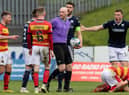 A free kick is given for a challenge on Partick's Brian Graham during a cinch Championship match between Partick Thistle and Dundee at Firhill.