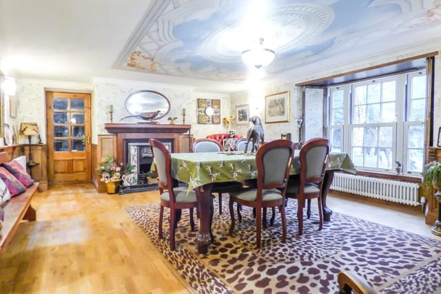 Dining room includes a decorative feature fire with feature tiled back and wooden mantel.